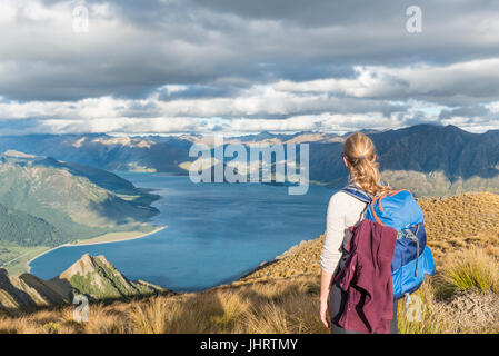 Female hiker looking at lake, Lake Hawea and mountain landscape, Isthmus Peak, Otago, South Island, New Zealand