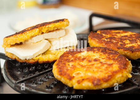 Traditional Colombian Arepa de Choclo Preparation : Grilling the stuffed corn bread Stock Photo