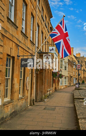 Chipping Campden High Street and a Union Jack flag flying from the from of a stone building in the Cotswold market town. Stock Photo