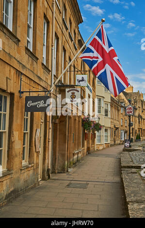 Chipping Campden High Street and a Union Jack flag flying from the from of a stone building in the Cotswold market town. Stock Photo