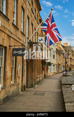 Chipping Campden High Street and a Union Jack flag flying from the from of a stone building in the Cotswold market town. Stock Photo