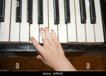 Kid Hands Holds Color Pencil And Think About Drawing Things On White Blank  Paper On Desk Or Study Table Stock Photo, Picture and Royalty Free Image.  Image 99341644.