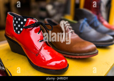 Macro closeup of vintage shoe display at store with bright red vibrant heel Stock Photo