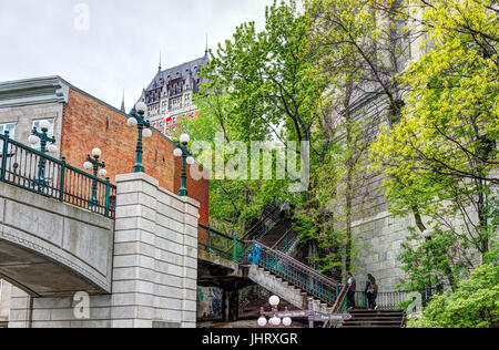 Quebec City, Canada - May 30, 2017: View of Porte Prescott bridge and Chateau Frontenac by old town street called Cote de la Montagne with stone build Stock Photo