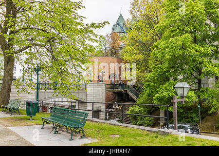 Quebec City, Canada - May 30, 2017: View of Porte Prescott bridge and Chateau Frontenac by old town street called Cote de la Montagne with stone build Stock Photo