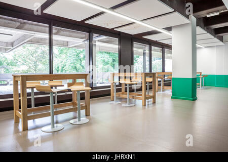 At a university school in the hallway there are several tables and chairs Stock Photo