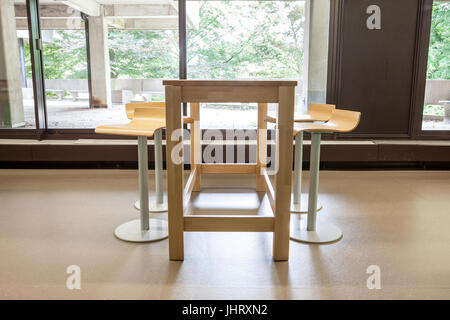 At a university school in the hallway there are several tables and chairs Stock Photo