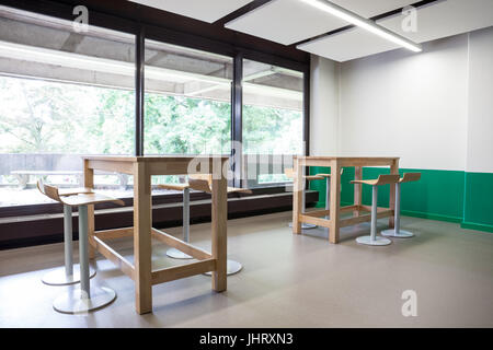 At a university school in the hallway there are several tables and chairs Stock Photo