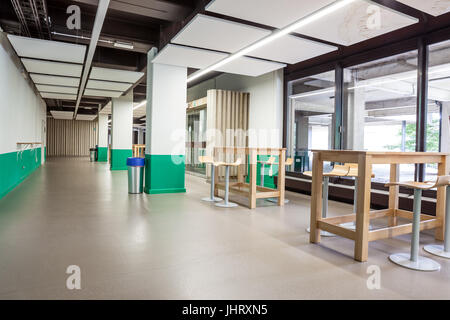 At a university school in the hallway there are several tables and chairs Stock Photo