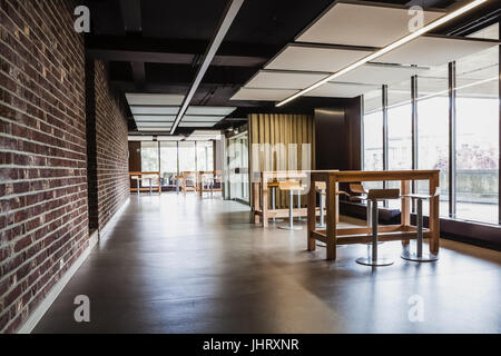 At a university school in the hallway there are several tables and chairs Stock Photo