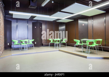 At a university school in the hallway there are several tables and chairs Stock Photo