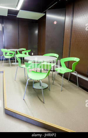 At a university school in the hallway there are several tables and chairs Stock Photo