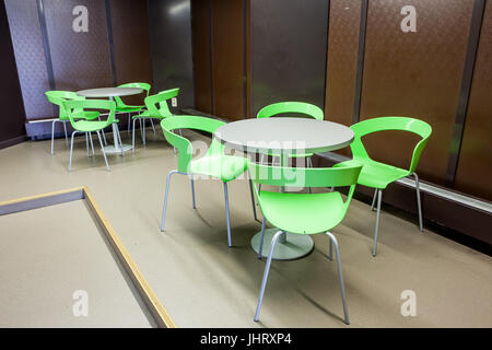 At a university school in the hallway there are several tables and chairs Stock Photo