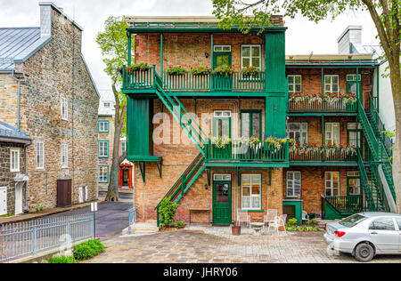 Quebec City, Canada - May 30, 2017: Closeup of old town residential building with balconies decorated with flowers by parc du Cavalier du Moulin Stock Photo
