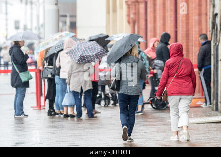 Blackpool, Lancashire, 15th July 2017. UK Weather.  Heavy rain downpours soak the shoppers as they head into Blackpool town centre.  Bad weather is expected to last all day with a chance of some brighter spells in the early evening.  Credit: Cernan Elias/Alamy Live News Stock Photo