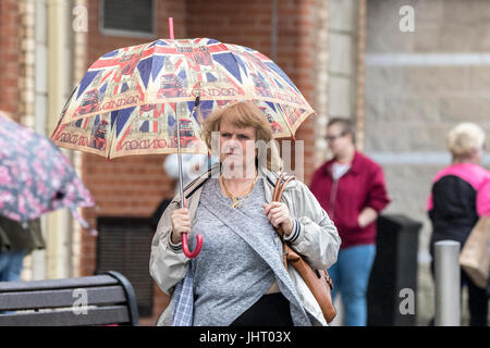 Blackpool, Lancashire, 15th July 2017. UK Weather.  Heavy rain downpours soak the shoppers as they head into Blackpool town centre.  Bad weather is expected to last all day with a chance of some brighter spells in the early evening.  Credit: Cernan Elias/Alamy Live News Stock Photo