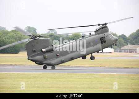 Visitors watched a RAF Boeing Chinook HC.4 taking to the sky in one of the most spectacular displays at this year's RIAT Air Show at RAF Fairford. This year there is a large contingent from the US to mark the 70th anniversary of the US Air Force. Credit: Uwe Deffner/Alamy Live News Stock Photo