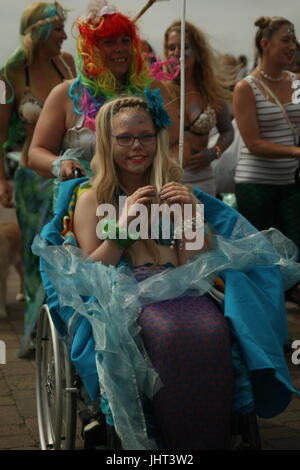 Brighton, UK, 15th July 2017. Brighton's annual March of the Mermaids, featuring many different mermaids, heads along the promenade. Marchers claim to be mermaids who once a year grow legs to take to the land and protest about the condition of the coast. This year's event was held in support of Surfers Against Sewage. Roland Ravenhill/Alamy Live News. Stock Photo