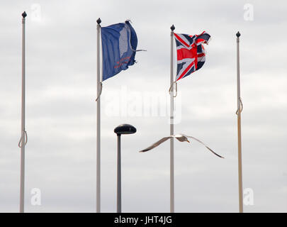 Portland, UK. 15th July, 2017. Flags fly in the steady breeze at Weymouth and Portland National Sailing Academy Credit: stuart fretwell/Alamy Live News Stock Photo