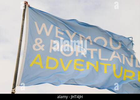 Portland, UK. 15th July, 2017. Flags fly in the steady breeze at Weymouth and Portland National Sailing Academy Credit: stuart fretwell/Alamy Live News Stock Photo