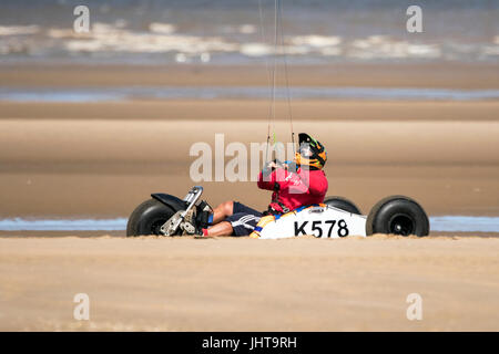 Southport, Merseyside, 16th July 2017. UK Weather.   A beautiful sunny start to the day over the north west coast of England as a land surfer catches the sea breeze on the golden sand of Southport beach in Merseyside.  With spells of gorgeous sunshine forecast to continue throughout the day, a lovely day is expected over the popular seaside resort.  Credit: Cernan Elias/Alamy Live News Stock Photo