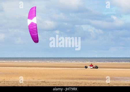 Southport, Merseyside, 16th July 2017. UK Weather.   A beautiful sunny start to the day over the north west coast of England as a land surfer catches the sea breeze on the golden sand of Southport beach in Merseyside.  With spells of gorgeous sunshine forecast to continue throughout the day, a lovely day is expected over the popular seaside resort.  Credit: Cernan Elias/Alamy Live News Stock Photo