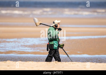 Southport, Merseyside, 16th July 2017. UK Weather.   A beautiful sunny start to the day over the north west coast of England as keen metal detectorists hunt for buried treasures on the golden sands of Southport beach in Merseyside.  With spells of gorgeous sunshine forecast to continue throughout the day, a lovely day is expected over the popular seaside resort.  Credit: Cernan Elias/Alamy Live News Stock Photo