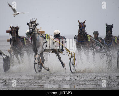 Cuxhaven, Germany. 16th July, 2017. Horses can be seen running on the tidal flats along the beach of Duhnen in Cuxhaven, Germany, 16 July 2017. The traditional tidal flat race in Duhnen is a tourist attraction at the North Sea Coast. The horses vie for victory and financial rewards along the tidal flats along the coast. Photo: Ingo Wagner/dpa/Alamy Live News Stock Photo