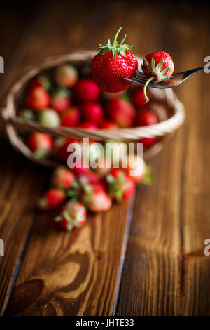 ripe red strawberries on a wooden table Stock Photo