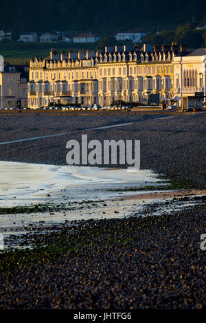 An early sunrise illuminating the many guest houses, hotels and b&b's on the seafront promenade at the popular seaside resort of Llandudno, Wales Stock Photo