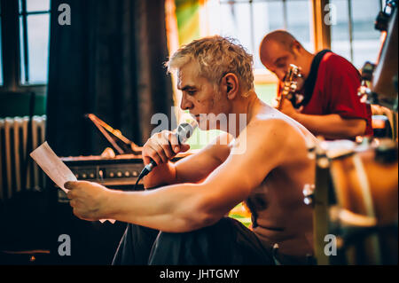 Behind the scene. Rock band practice in the messy recording music studio. Alternative musician group live playing Stock Photo