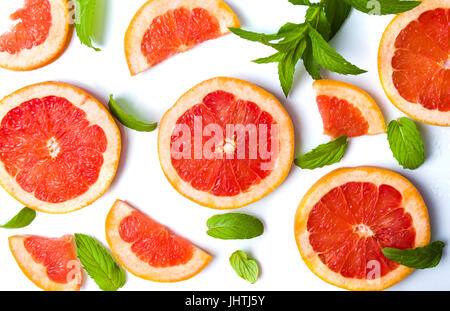 Grapefruit slices and mint leaves isolated on white Stock Photo