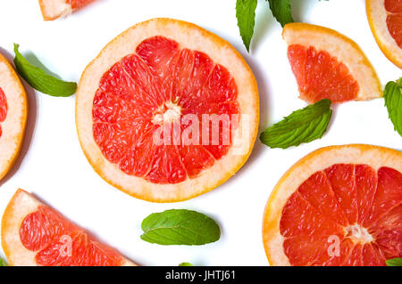 Grapefruit slices and mint leaves isolated on white Stock Photo
