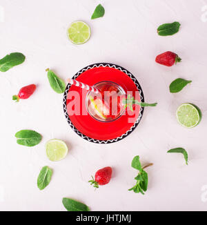Fresh lemonade with strawberries, lime and mint in a tall glass on a white background Stock Photo