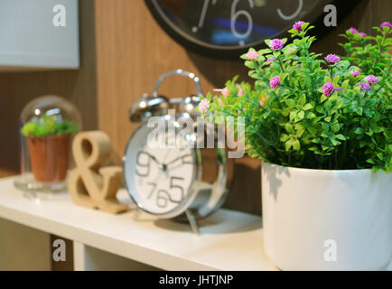 Bedhead decoration with plants and clock with selective focus Stock Photo