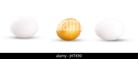 one golden egg with two white isolated on white background. Stock Photo