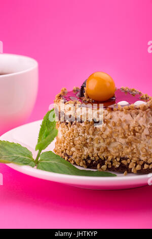 Sweet cake with mint leaves. On a pink background. Birthday dessert. Stock Photo