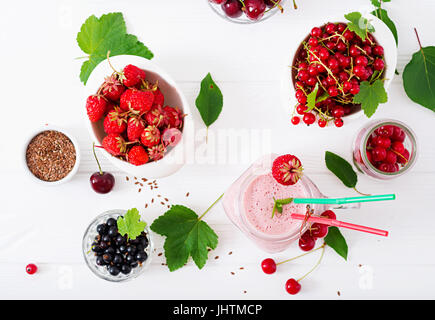 Yoghurt-strawberry smoothies in a jar on a white background. Flat lay. Top view Stock Photo