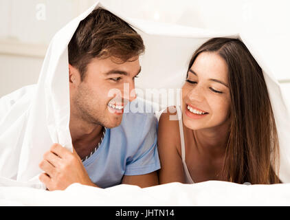 Young couple playing under the sheets Stock Photo