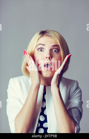 Blonde with hands at face Stock Photo