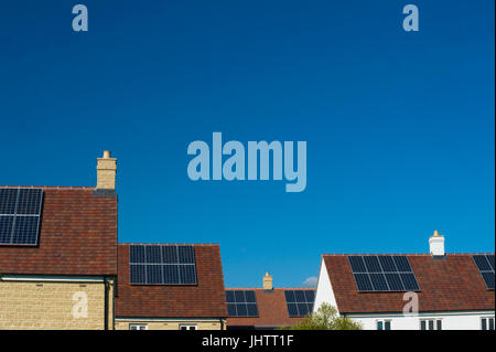 Solar panels fitted to the roofs of domestic houses during construction in Oxfordhire, UK.solar panels Stock Photo