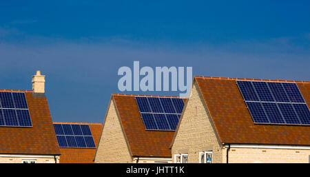 Solar panels fitted to the roofs of domestic houses during construction in Oxfordhire, UK.solar panels Stock Photo