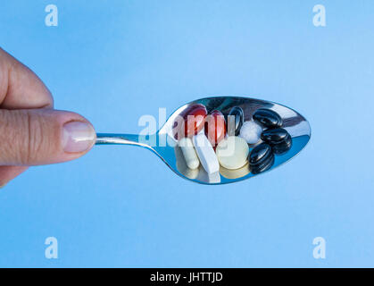 Spoon full of tablets Stock Photo
