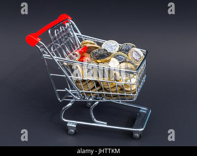 Shopping basket full on new one pound coins Stock Photo