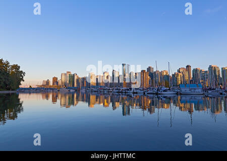 Vancouver downtown skyline reflection at sunset, Canada. Scenic urban landscape as seen from Stanley Park.