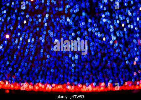 Bokeh-abstraction: glowing luminous blue theater curtain with fiery red edging Stock Photo