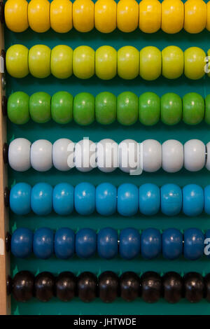 Abacus counting frame. Calculating tool with rainbow colored beads sliding on wires. Used in pre- and in elementary schools as an aid in teaching the Stock Photo