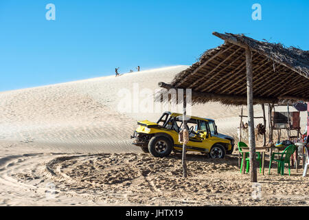 Jericoacoara, Ceara state, Brazil - July 17, 2016: Buggy and moto with tourists traveling through the desert Jericoacoara National Park Stock Photo