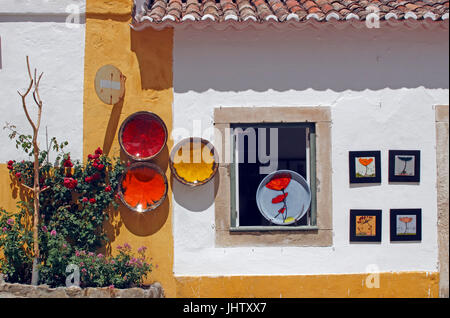 Ceramic art bowls for sale in shop whitewashed village of Obidos Estremadura Portugal Stock Photo