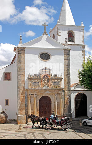 Horse drawn carriage in plaza of Santa Maria Church whitewashed village of Obidos Estremadura Portugal Stock Photo
